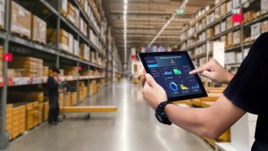 Man Holding a Tablet executing Warehouse Management