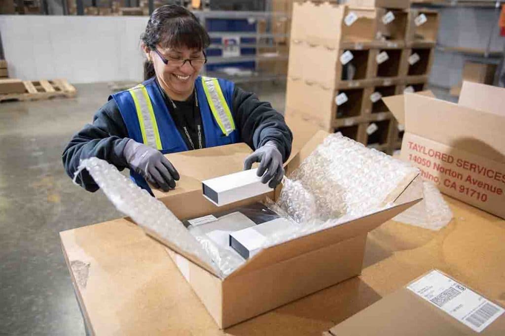 Woman Packaging A Box