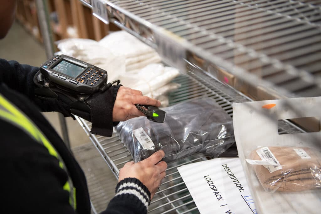 Employee Scanning A Package's Barcode