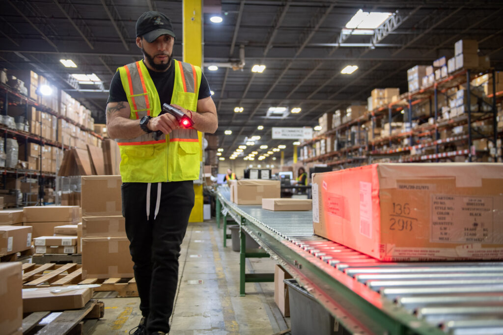Man Holding A Wireless Scanning Gun For Storage