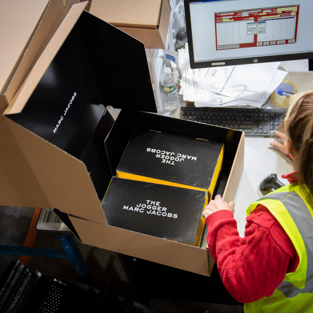 Woman Adding A Package To Inventory Tool