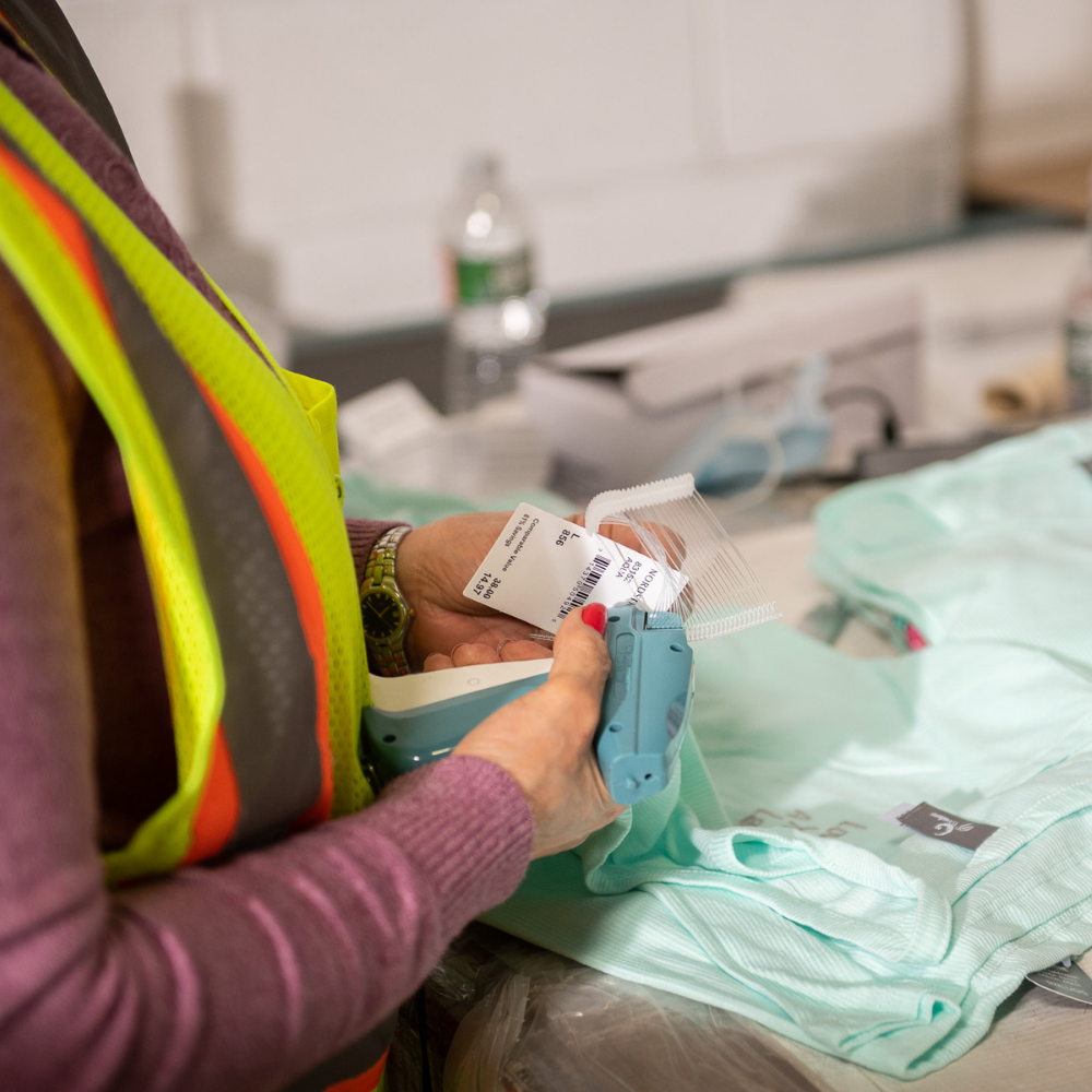 Worker Checking The Barcode Of A Package